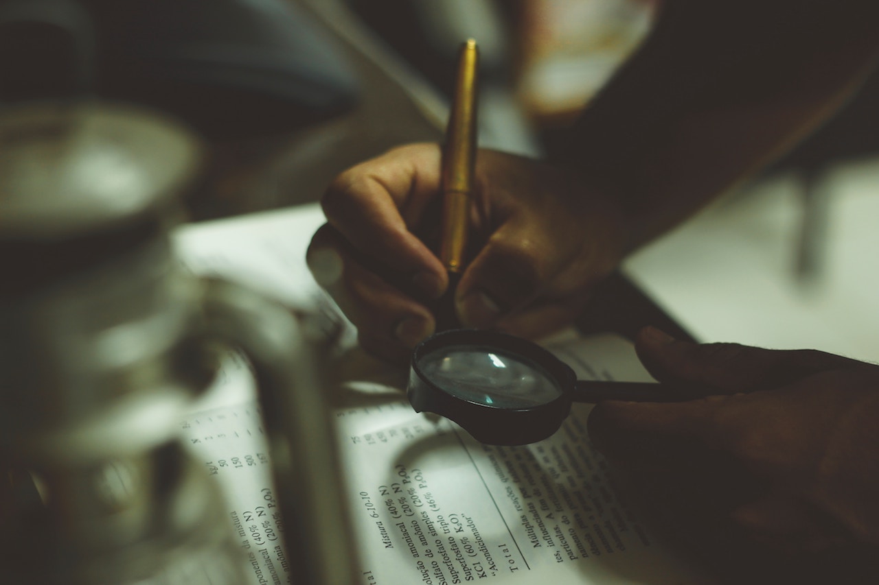 person holding magnifying glass